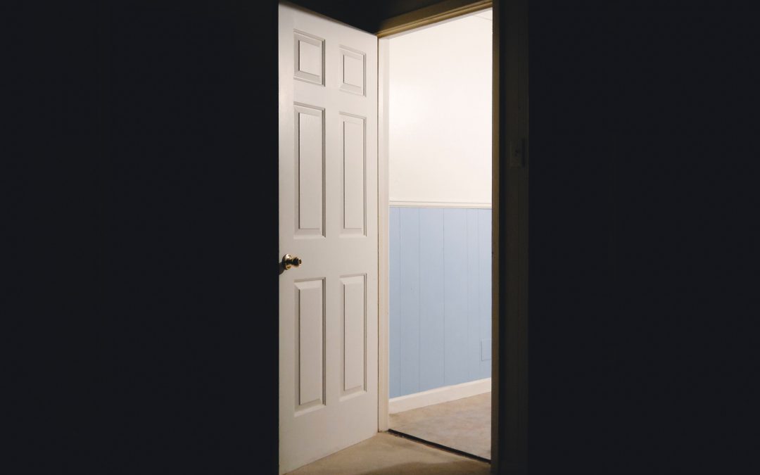 Image: an open door.